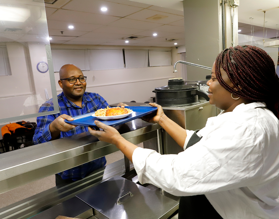 A volunteer serving a client